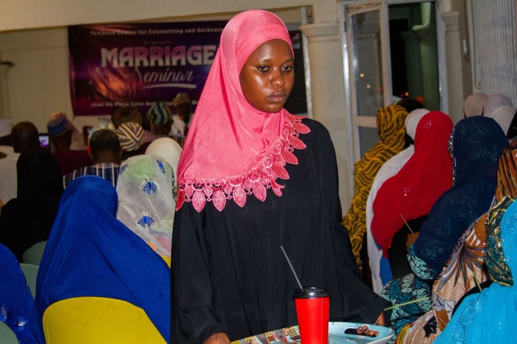 Participants gathered at the Marriage Seminar with banner visible at the front