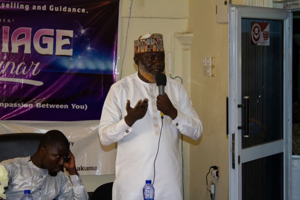 Speaker addressing the Marriage Seminar with banner visible behind