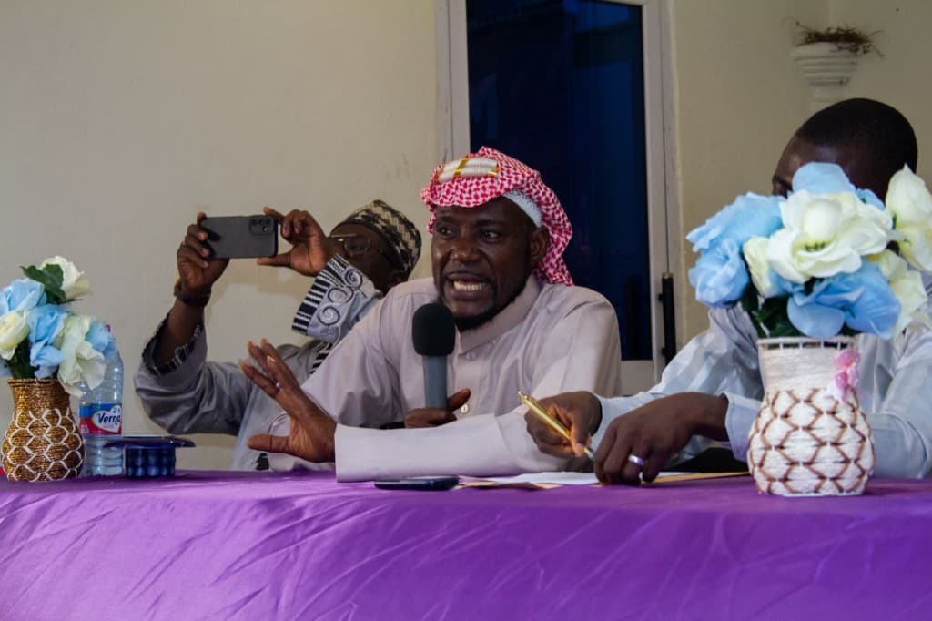 Speaker addressing the Marriage Seminar with microphone in hand